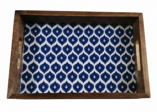 Wooden tray with blue and white patterned fabric inside on a white background