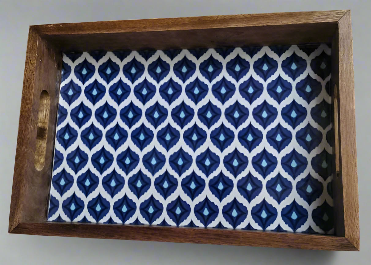 Wooden tray with a blue and white patterned fabric cover on a gray background