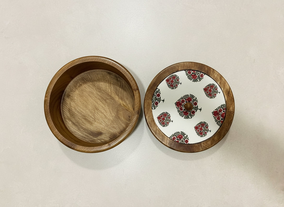 Wooden bowl with a floral-patterned lid on a gray background