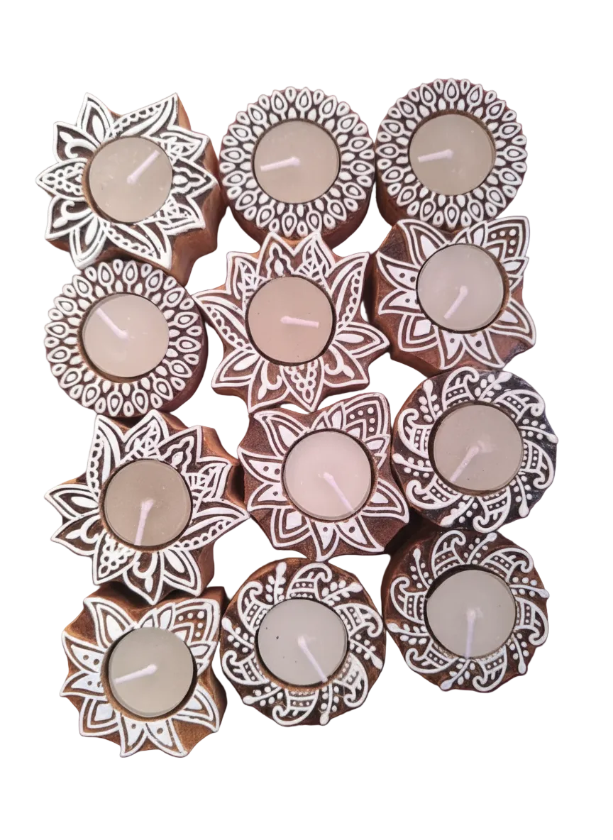 Decorative candles in floral holders on a white background

