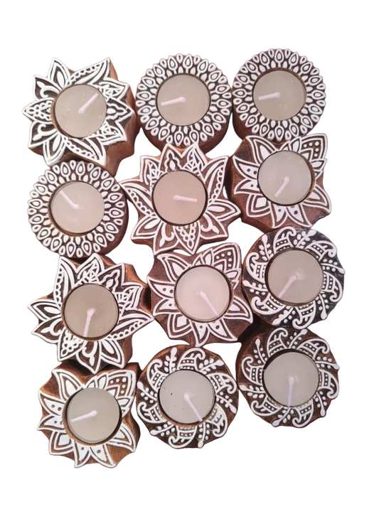 Decorative candles in floral holders on a white background

